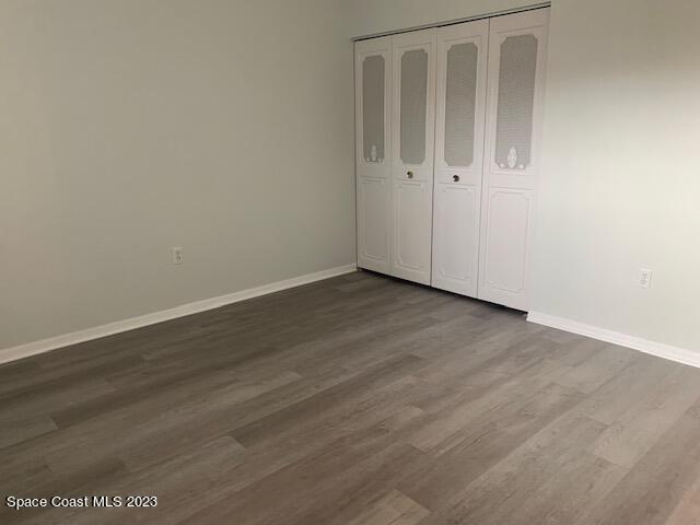 unfurnished bedroom featuring a closet and wood-type flooring