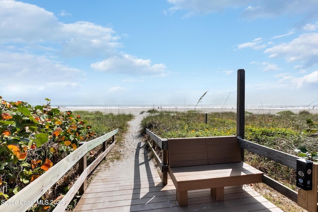 surrounding community with a view of the beach and a water view