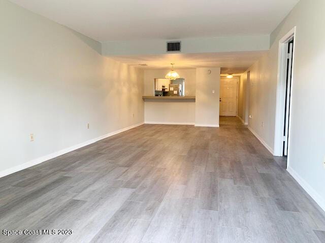 unfurnished living room featuring hardwood / wood-style flooring