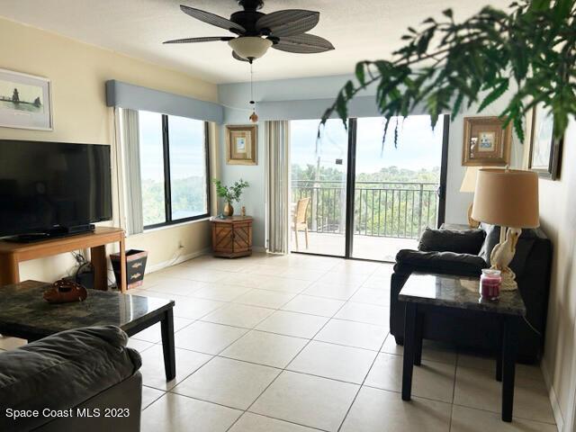 tiled living room with ceiling fan