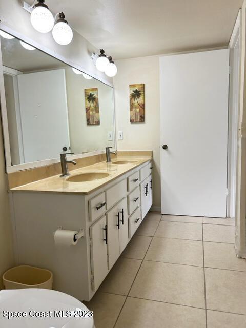 bathroom featuring tile patterned floors, vanity, and toilet