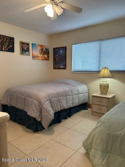 tiled bedroom with ceiling fan