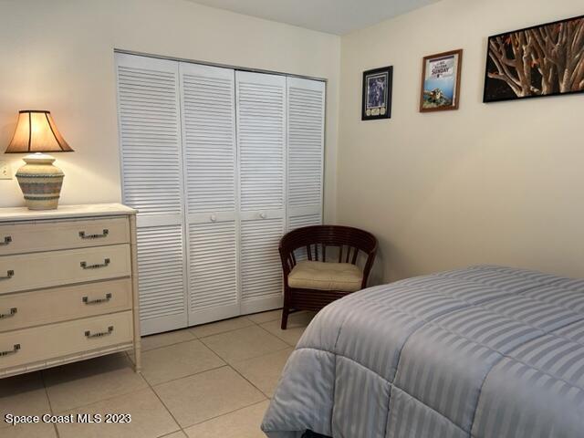 tiled bedroom featuring a closet