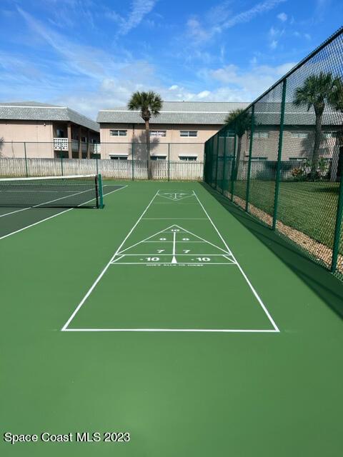 view of property's community featuring tennis court