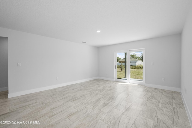 spare room with visible vents and baseboards