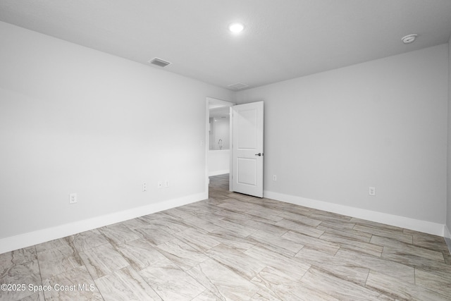 spare room with visible vents and baseboards