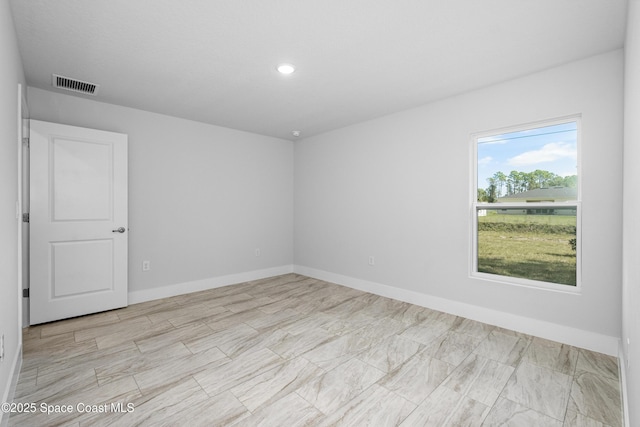 unfurnished room featuring recessed lighting, visible vents, and baseboards