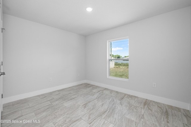 empty room with baseboards and recessed lighting