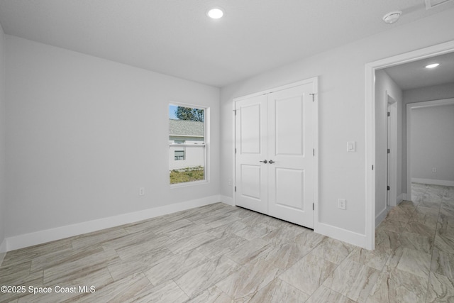 unfurnished bedroom featuring recessed lighting, a closet, and baseboards