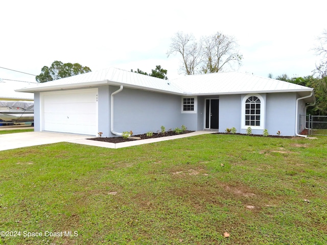 ranch-style house with a garage and a front lawn