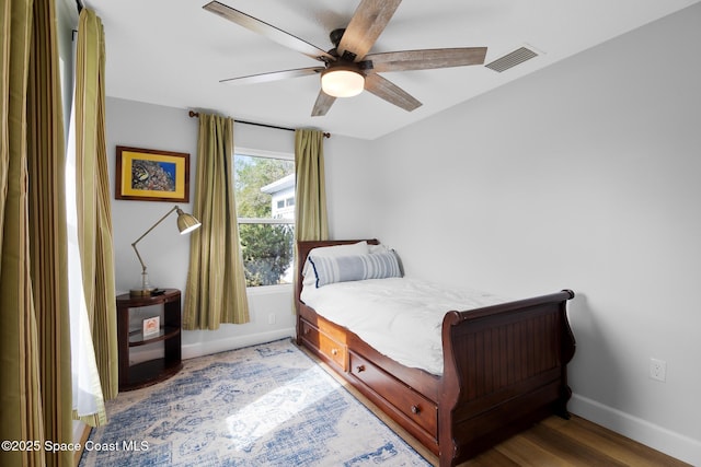 bedroom with ceiling fan and dark hardwood / wood-style flooring