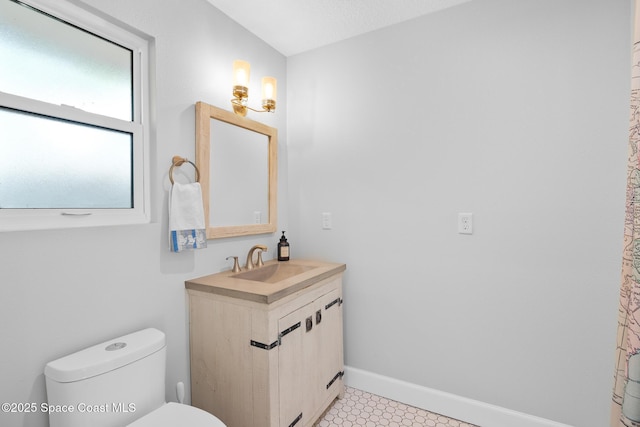 bathroom featuring toilet and vanity