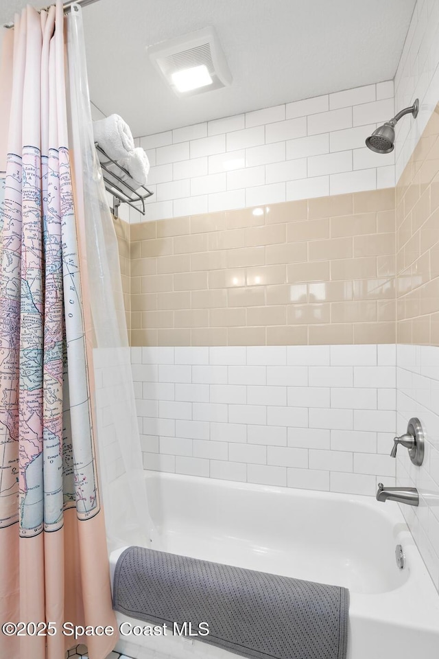 bathroom featuring shower / bathtub combination with curtain