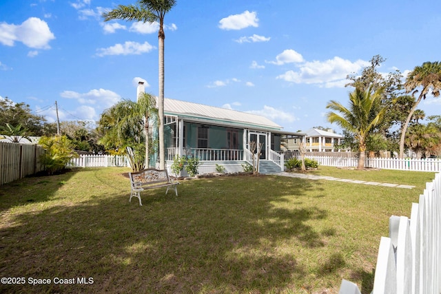 view of front of home featuring a front lawn and a sunroom