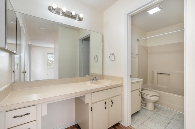 full bathroom featuring bathing tub / shower combination, tile patterned floors, a textured ceiling, toilet, and vanity