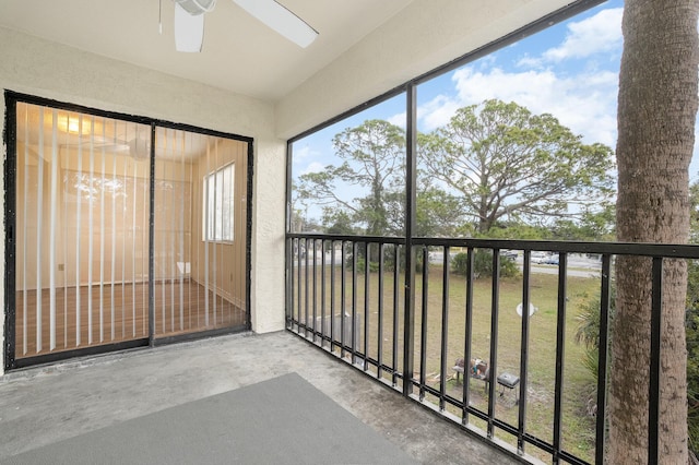 unfurnished sunroom with ceiling fan