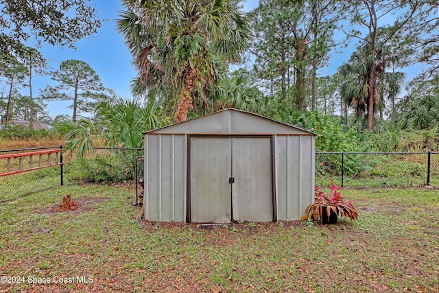 view of outbuilding featuring a lawn