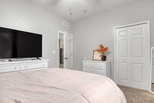 bedroom featuring ceiling fan, a closet, and carpet floors