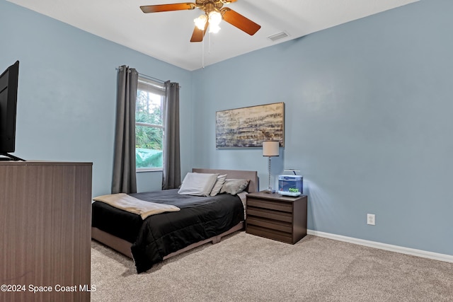 bedroom featuring ceiling fan and light carpet