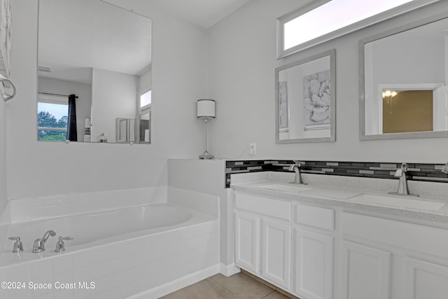 bathroom featuring tile patterned floors, a bathtub, and vanity