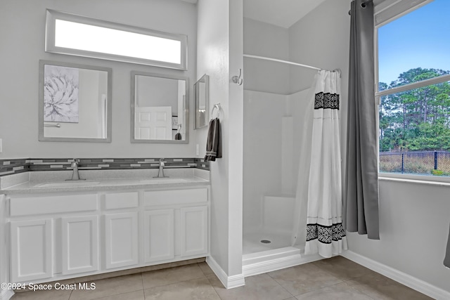 bathroom featuring tile patterned floors, curtained shower, and a healthy amount of sunlight