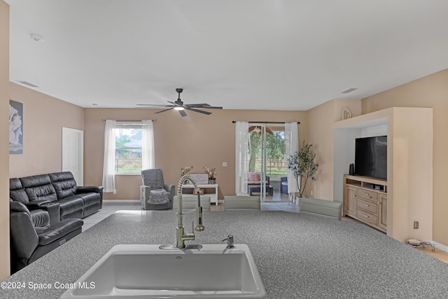 living room with ceiling fan and sink