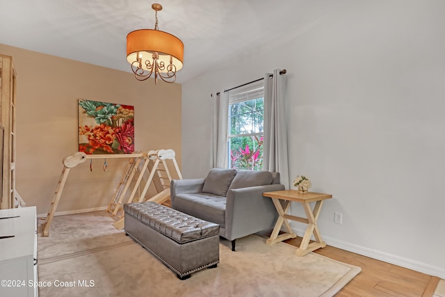 living area featuring hardwood / wood-style floors and a notable chandelier