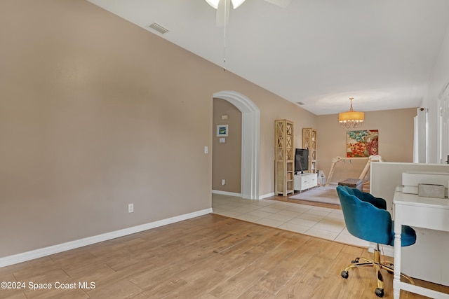 unfurnished office featuring light hardwood / wood-style flooring and a chandelier