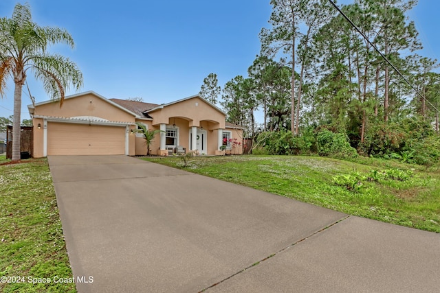 view of front of house featuring a front lawn and a garage