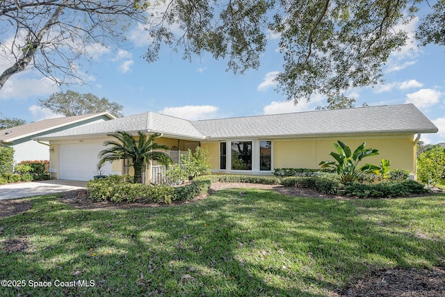 ranch-style house featuring a garage and a front yard