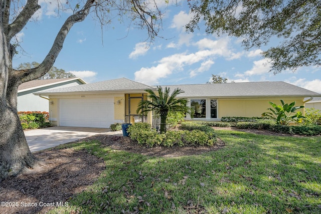 ranch-style house featuring a garage and a front yard