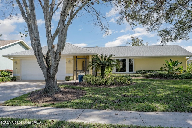 ranch-style home featuring a garage and a front yard