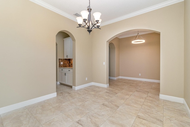 spare room featuring a chandelier and ornamental molding