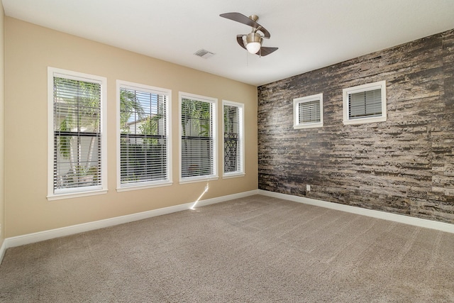 empty room with carpet flooring and ceiling fan