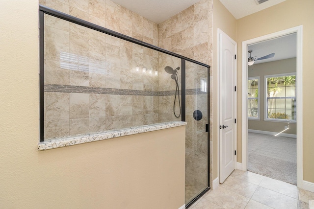 bathroom with ceiling fan, tile patterned flooring, and a shower with shower door