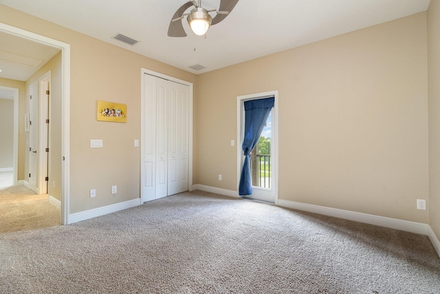 unfurnished bedroom featuring carpet, access to exterior, a closet, and ceiling fan