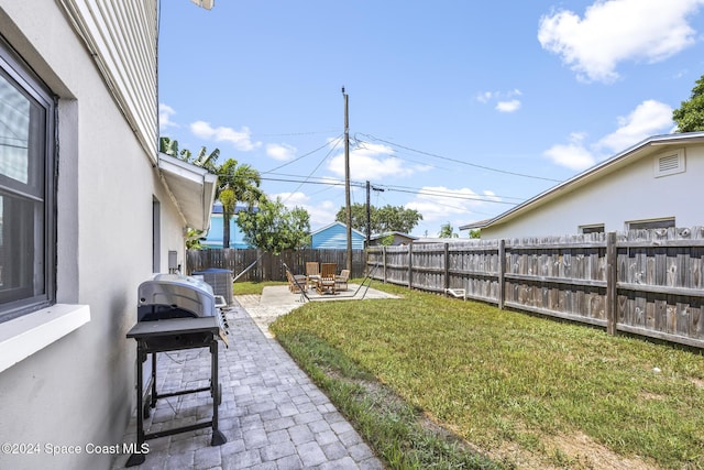 view of yard with cooling unit and a patio area