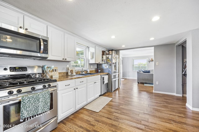 kitchen with white cabinetry, sink, a healthy amount of sunlight, and appliances with stainless steel finishes