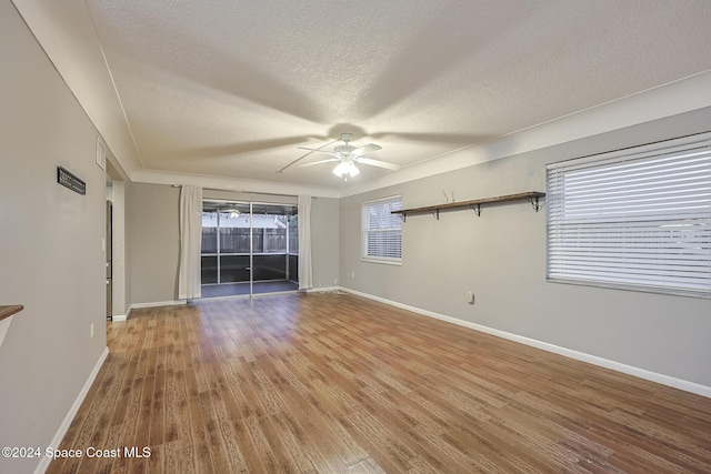 spare room with a textured ceiling, hardwood / wood-style flooring, and ceiling fan