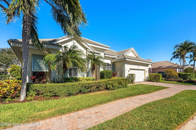 view of front facade with a front lawn and a garage