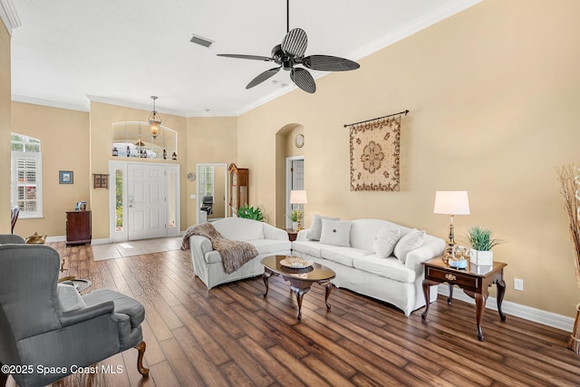 living room featuring crown molding, dark hardwood / wood-style flooring, and ceiling fan