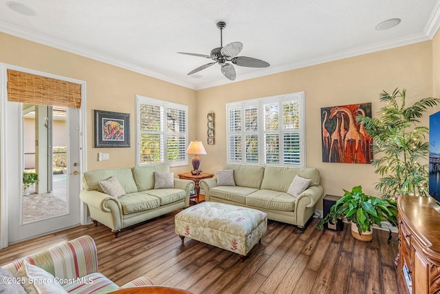 living room featuring a wealth of natural light, hardwood / wood-style floors, ceiling fan, and ornamental molding