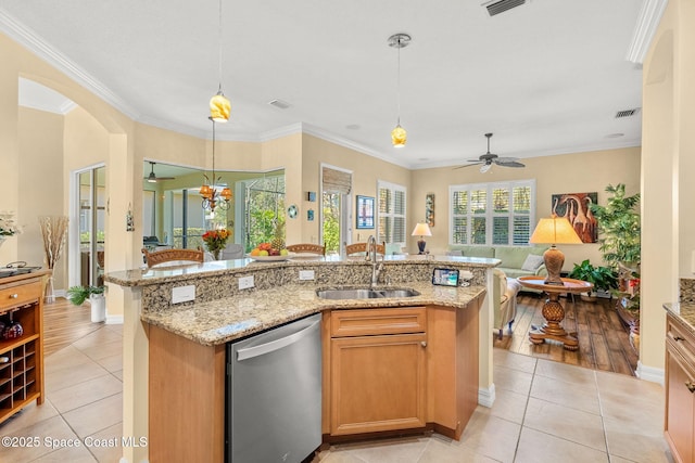 kitchen with stainless steel dishwasher, light stone counters, ceiling fan, pendant lighting, and light tile patterned floors