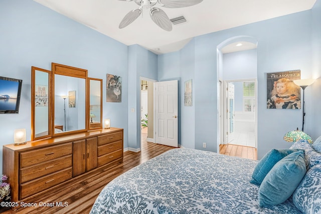 bedroom featuring ensuite bathroom, ceiling fan, and wood-type flooring