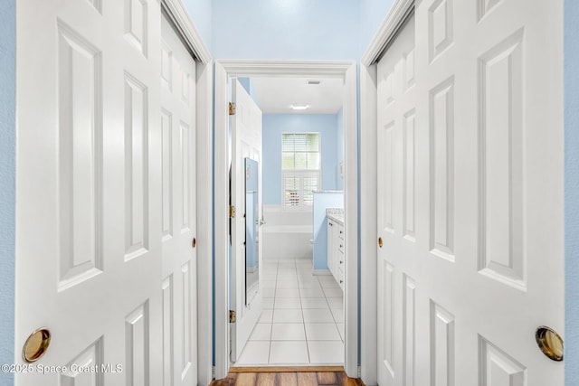 hall with light tile patterned floors