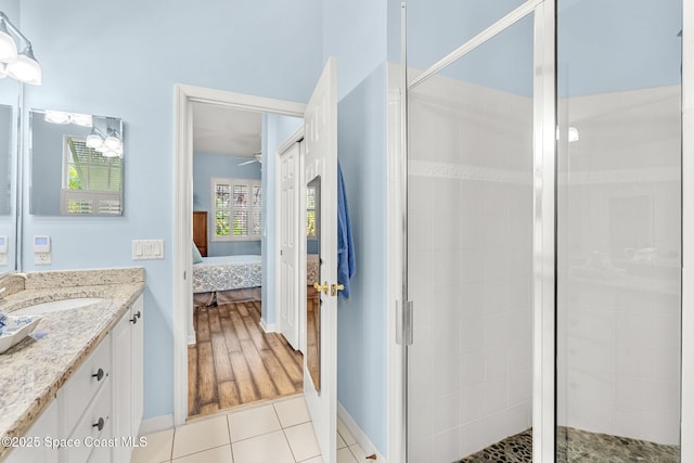 bathroom featuring tile patterned floors, vanity, and walk in shower