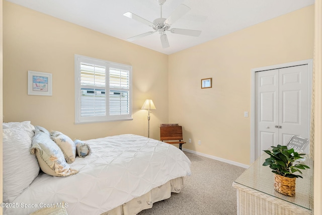 carpeted bedroom featuring ceiling fan and a closet