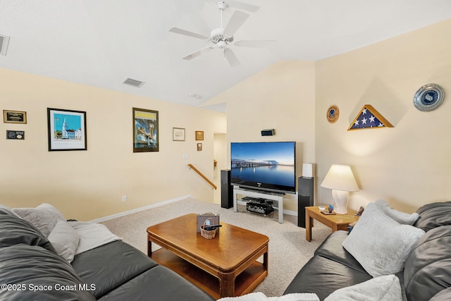 carpeted living room with ceiling fan and vaulted ceiling