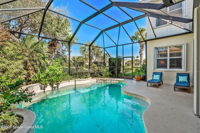 view of pool with a patio and a lanai