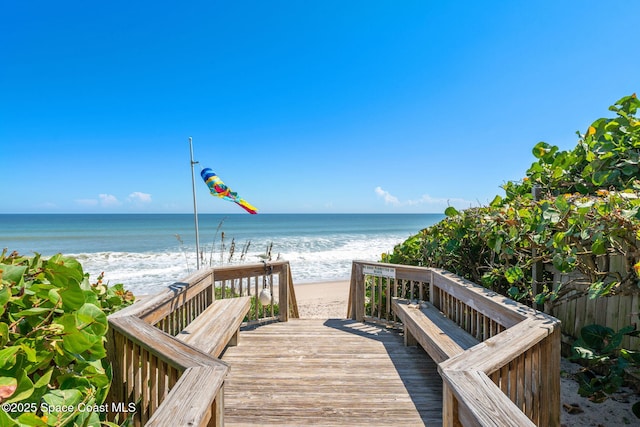 surrounding community with a view of the beach and a water view